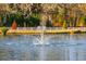 Pond with a fountain and white fence in the background at 4285 Clover Hill Rd, Green Pond, SC 29446
