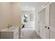Bright laundry room with utility sink and herringbone floor at 4285 Clover Hill Rd, Green Pond, SC 29446
