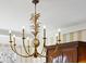 Ornate gold chandelier with unique design in dining room at 4285 Clover Hill Rd, Green Pond, SC 29446