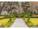 Serene garden path leading to a fountain, surrounded by Spanish moss trees at 4285 Clover Hill Rd, Green Pond, SC 29446