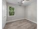 Bright bedroom with wood-look floors, large window, and double doors to closet at 168 Aleene Dr, Summerville, SC 29485