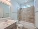 Bathroom with shower/tub combo, gray tile, and a white vanity at 2600 Josiah St, Charleston, SC 29492