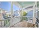 Screened porch with wooden flooring and seating area, overlooking the yard at 2600 Josiah St, Charleston, SC 29492