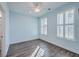 Light blue bedroom with wood flooring, white shutters, and ceiling fan at 2600 Josiah St, Charleston, SC 29492