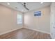 Bedroom with wood floors, neutral walls, ceiling fan and mounted TV at 2600 Josiah St, Charleston, SC 29492