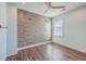 Bedroom with wood flooring, tile accent wall, and ceiling fan at 2600 Josiah St, Charleston, SC 29492