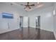 Primary bedroom with hardwood floors, ceiling fan and access to bathroom at 2600 Josiah St, Charleston, SC 29492