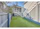 Artificial turf backyard with a wooden fence and stairs at 2600 Josiah St, Charleston, SC 29492