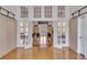 Hallway with hardwood floors and French doors opening to a meeting room at 1735 Atlantic Ave, Sullivans Island, SC 29482