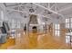 Large meeting room with a stone fireplace and hardwood floors at 1735 Atlantic Ave, Sullivans Island, SC 29482