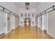 Long hallway with hardwood floors, leading to a large room with high ceilings at 1735 Atlantic Ave, Sullivans Island, SC 29482
