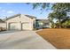 Brick house with a two-car garage and a spacious lawn at 1894 Capri Dr, Charleston, SC 29407