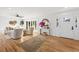 Bright living room with hardwood floors, comfy seating, and large windows at 1894 Capri Dr, Charleston, SC 29407