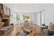 Bright living room features a fireplace, hardwood floors, and French doors opening to a view at 1894 Capri Dr, Charleston, SC 29407