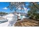 White brick home with teal accents and a two-car garage at 1894 Capri Dr, Charleston, SC 29407