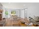 Bright living room features a fireplace, hardwood floors, and French doors opening to a view at 1894 Capri Dr, Charleston, SC 29407