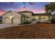 White brick home with teal shutters and a teal door at dusk at 1894 Capri Dr, Charleston, SC 29407