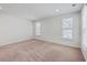 Well-lit bedroom featuring neutral carpeting and two windows at 2250 Kemmerlin St, Johns Island, SC 29455