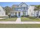 Two-story white house with gray shutters, front porch, and landscaped lawn at 2250 Kemmerlin St, Johns Island, SC 29455