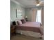 King bedroom with plush bedding and calming coastal decor at 106 W Arctic Avenue Ave # 3-J, Folly Beach, SC 29439