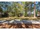 Home with a spacious backyard and lush trees at 4294 Club Course Dr, North Charleston, SC 29420