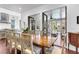 Bright dining room with a large wooden table and access to a porch at 64 Warren St, Charleston, SC 29403