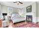 Spacious bedroom with a fireplace, large bed, and hardwood floors at 64 Warren St, Charleston, SC 29403