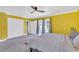 Bedroom with yellow walls, gray carpet, and ample closet space at 428 Carn St, Walterboro, SC 29488