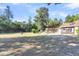 Large backyard with spacious grassy area, trees, and playset at 428 Carn St, Walterboro, SC 29488
