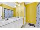 Clean bathroom with double vanity and yellow walls at 428 Carn St, Walterboro, SC 29488