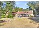 Backyard view of brick house with playset and large yard at 428 Carn St, Walterboro, SC 29488