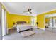 Bright bedroom with yellow walls, gray carpet, and a ceiling fan at 428 Carn St, Walterboro, SC 29488