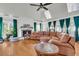 Spacious living room with hardwood floors, large windows, a fireplace, and a sectional sofa at 428 Carn St, Walterboro, SC 29488