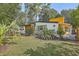 Mid-century modern home with teal door and landscaping at 32 Briarcliff Dr, Charleston, SC 29407