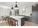 Modern kitchen with dark cabinetry, marble island, and herringbone floors at 3 Penn Ave, Charleston, SC 29407