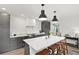 Modern kitchen with dark cabinetry, marble island, and herringbone floors at 3 Penn Ave, Charleston, SC 29407