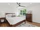 Spacious bedroom with a wooden bed frame and large window at 3 Penn Ave, Charleston, SC 29407