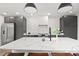 Modern kitchen with dark cabinetry, marble countertops and island at 3 Penn Ave, Charleston, SC 29407