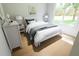 Charming bedroom with queen bed, hardwood floors, and large window at 7636 Indigo Palms Way, Johns Island, SC 29455