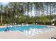 Community pool with multiple lounge chairs and accessible entry at 730 Breakers Reef Ln, Huger, SC 29450