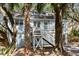 Quaint beach house with white stairs and tree-lined driveway at 522 Cobby Creek Ln, Seabrook Island, SC 29455