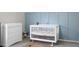 Bedroom with crib, dresser, and calming blue accent wall at 370 Spruce Ivy St, Moncks Corner, SC 29461