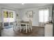 Bright dining room features a table with four chairs and sliding glass doors leading to the backyard at 370 Spruce Ivy St, Moncks Corner, SC 29461