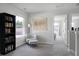 Bright sitting area with a chair, ottoman, bookshelf, and view of the backyard at 370 Spruce Ivy St, Moncks Corner, SC 29461