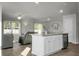 Modern kitchen with white cabinets, island, stainless steel appliances, and hardwood floors at 370 Spruce Ivy St, Moncks Corner, SC 29461