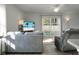 Cozy living room with gray sofas and a large TV at 370 Spruce Ivy St, Moncks Corner, SC 29461