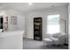 Upstairs sitting area with a comfy chair, ottoman, bookcase, and window seat at 370 Spruce Ivy St, Moncks Corner, SC 29461