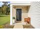 Front entrance with brick columns, a bench, and a black door at 370 Spruce Ivy St, Moncks Corner, SC 29461