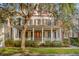 Charming two-story home with a large front porch and mature oak tree at 20 Perseverance St, Mount Pleasant, SC 29464