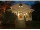 Charming white farmhouse with screened porch and inviting steps at 8057 Point Of Pines Rd, Edisto Island, SC 29438